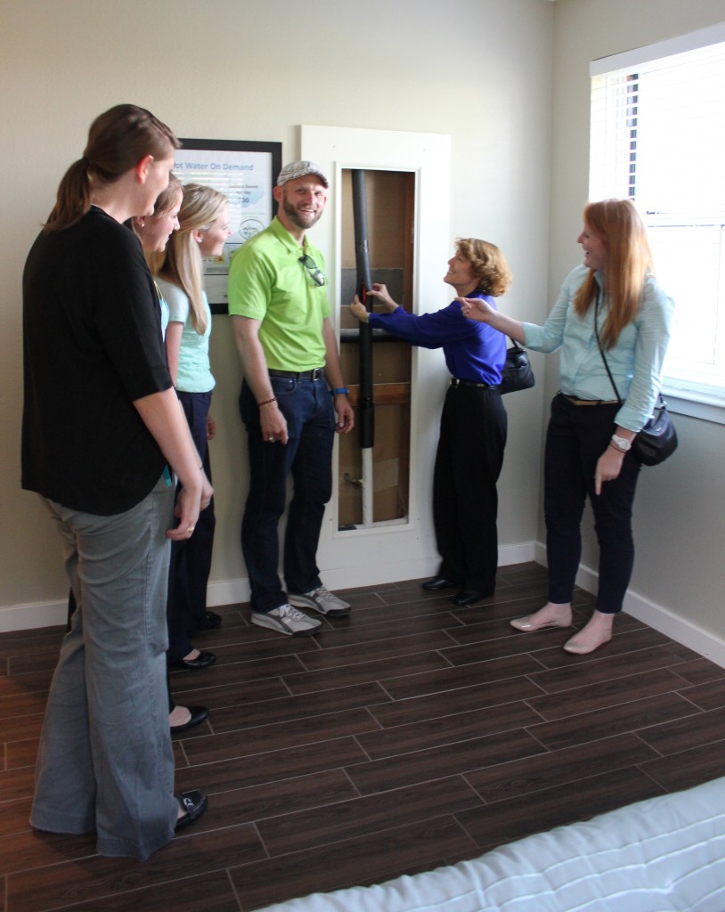 Attendees checking out the special plumbing for the On Demand Hot Water System