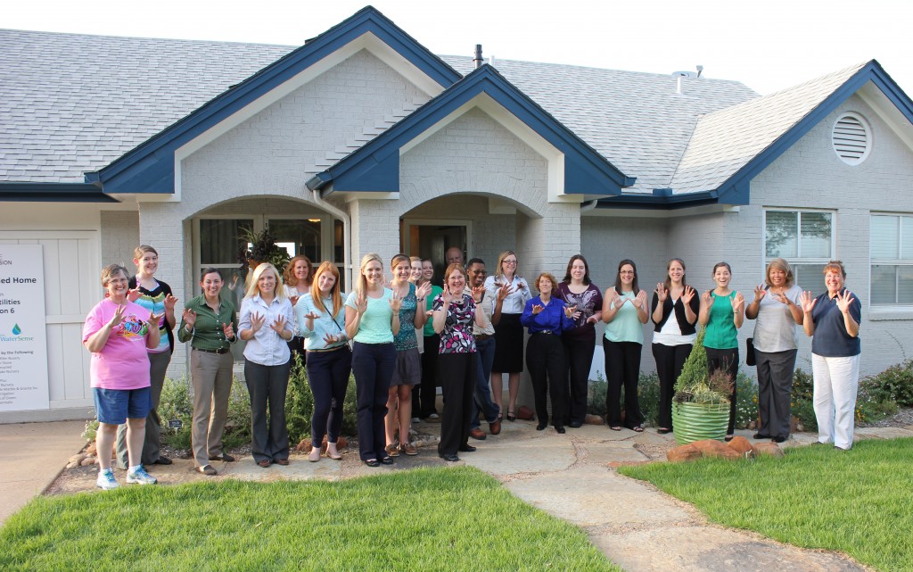 Group photo in front of the Watersense home, doing our best rainfall fingers!